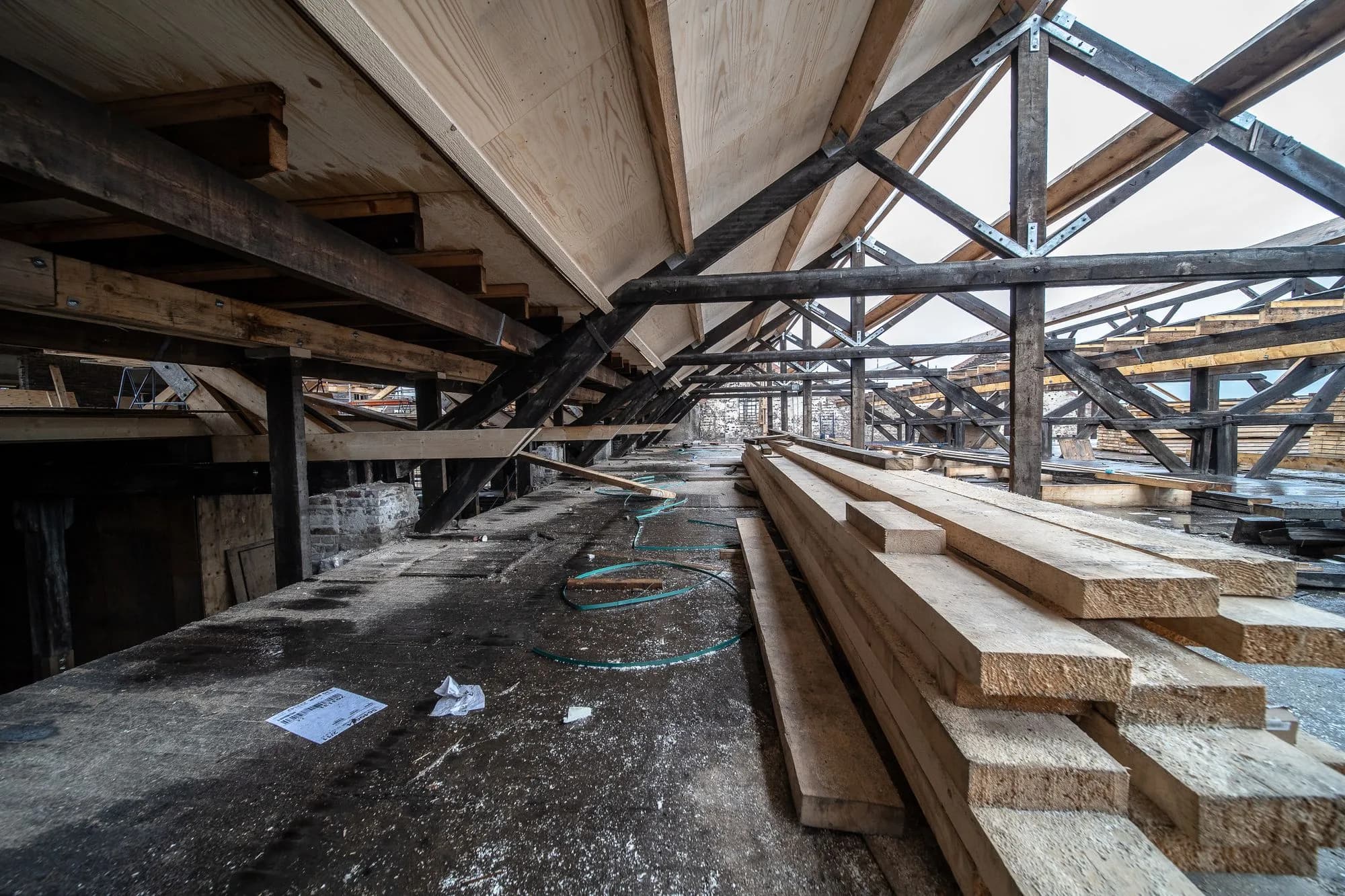 Detailed view of built-up wooden beams and posts in a deck structure under construction, showing what size beam a deck needs